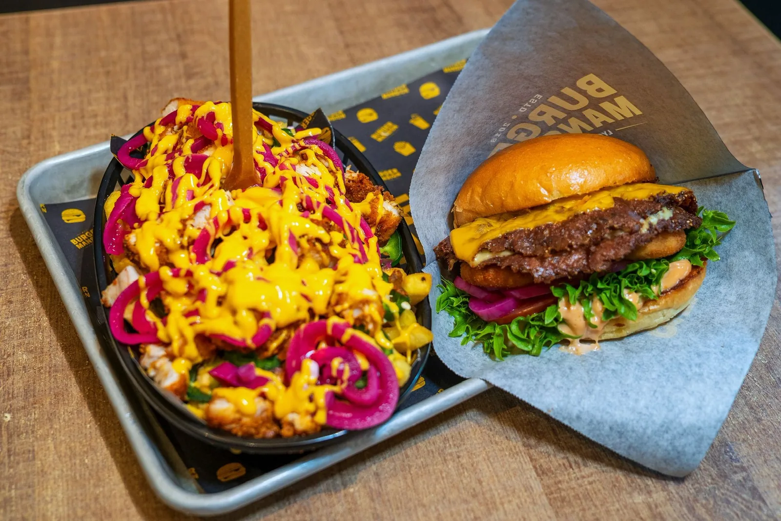 Saftig burgare och loaded fries på en bricka från Burger Mansion Malmö